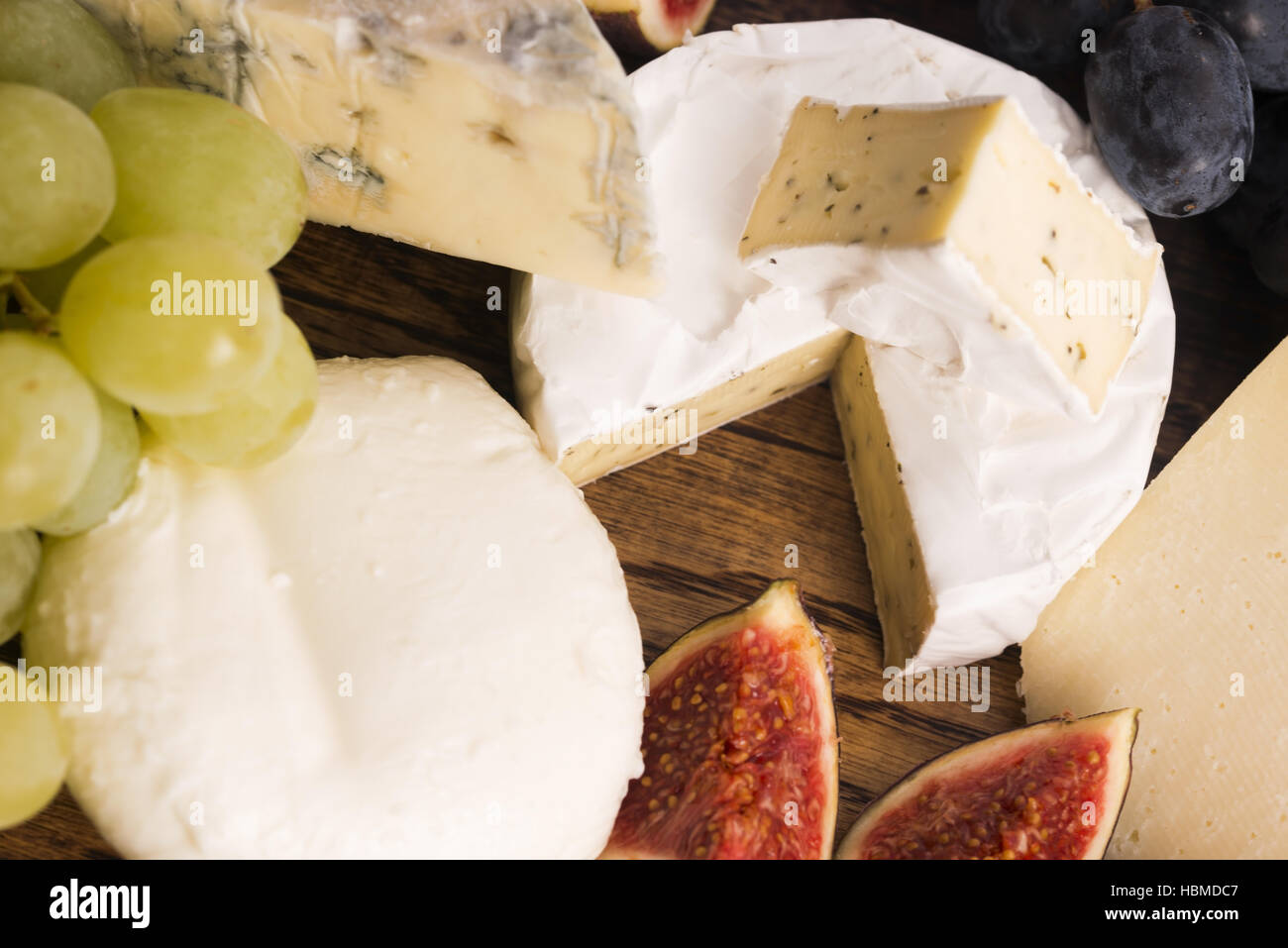 Assortment of cheese with fruits and grapes Stock Photo Alamy