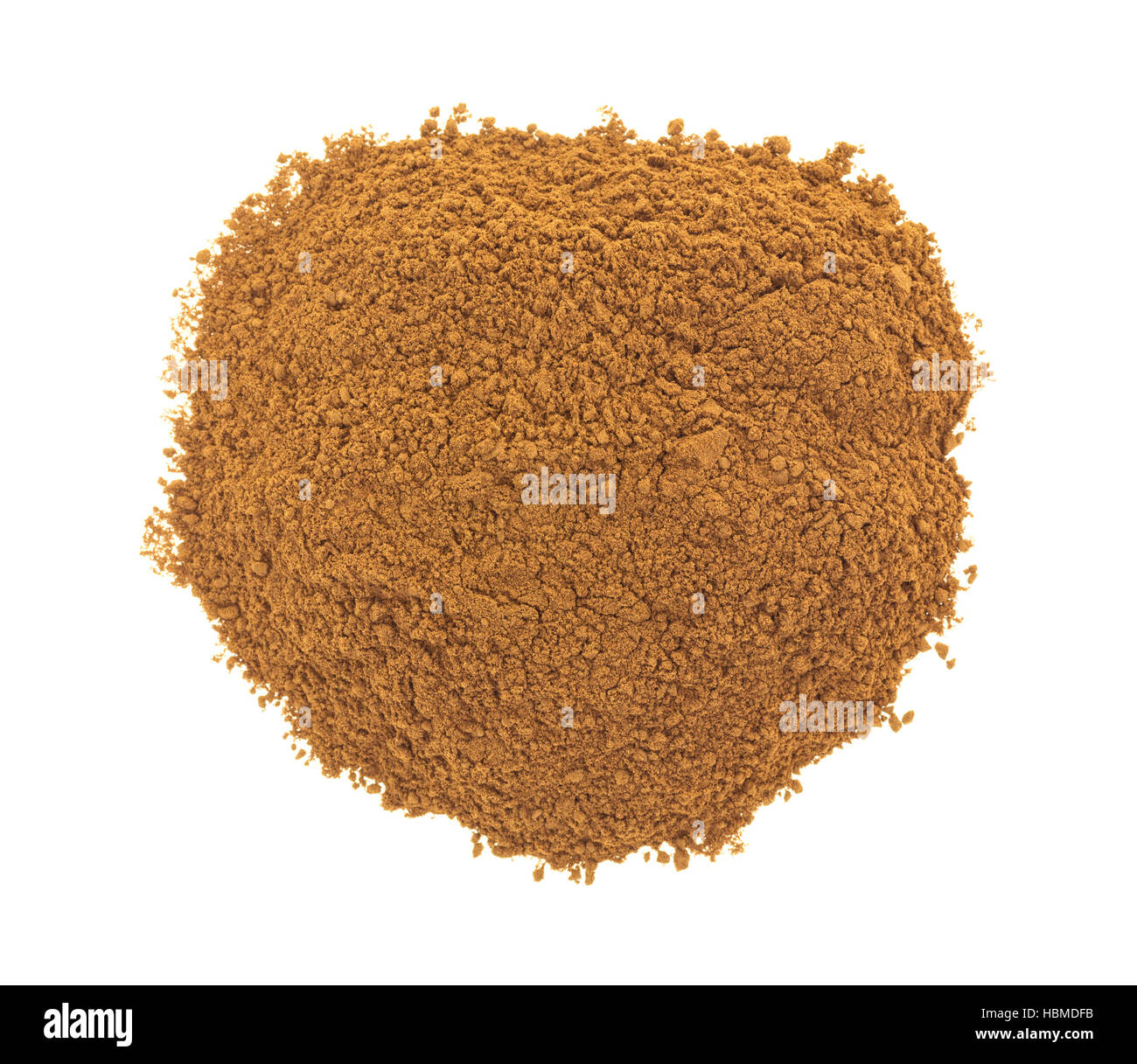 Top view of a small serving of carob powder isolated on a white background. Stock Photo