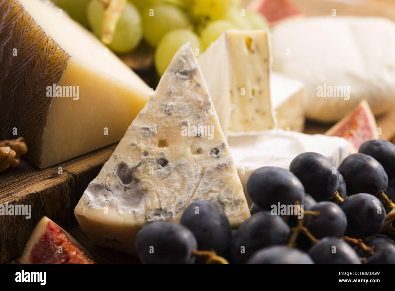 Assortment of cheese with fruits and grapes Stock Photo Alamy