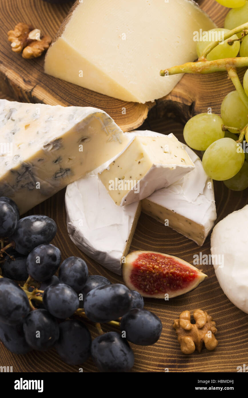 Assortment of cheese with fruits and grapes Stock Photo Alamy