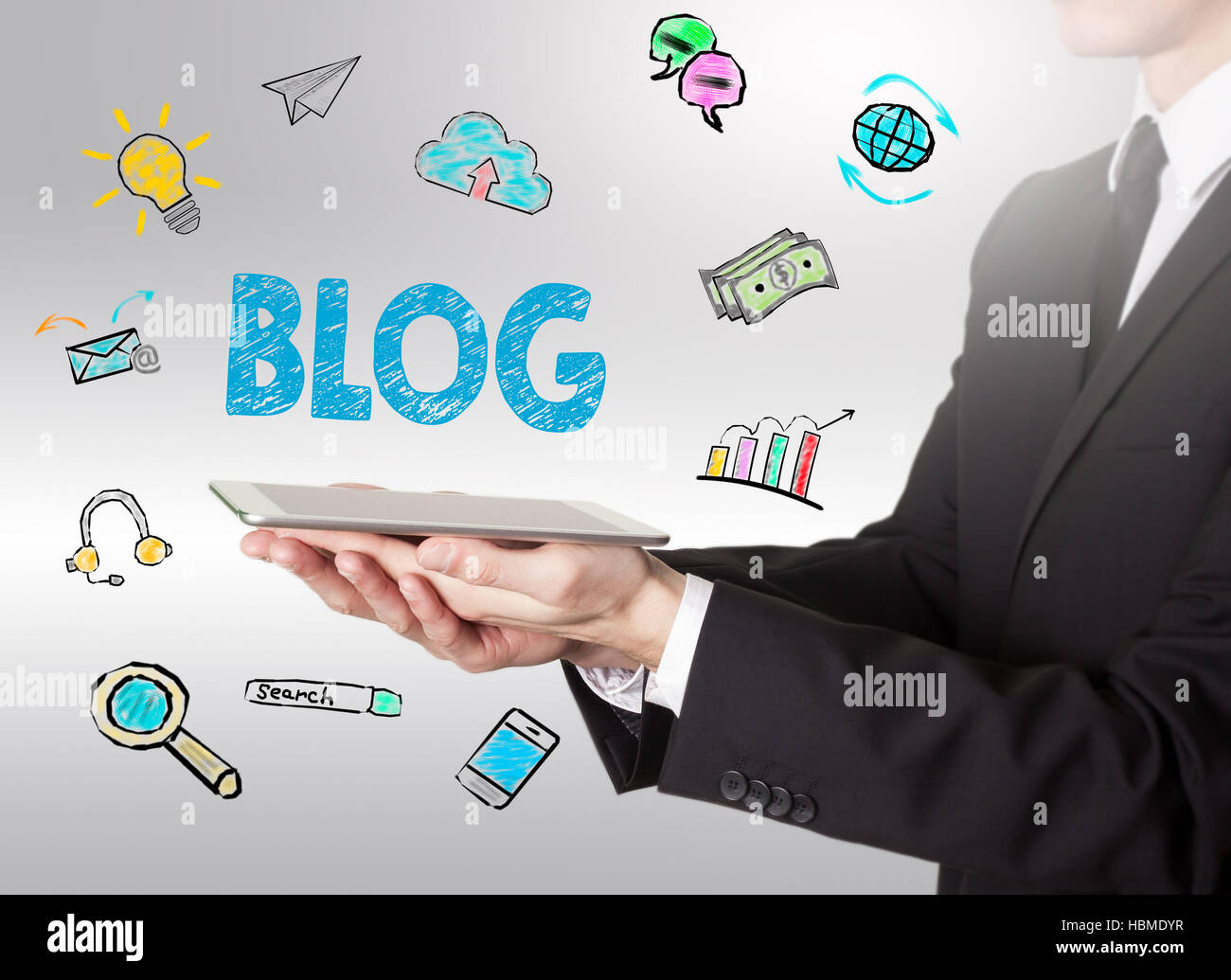 Blog concept, young man holding a tablet computer Stock Photo - Alamy