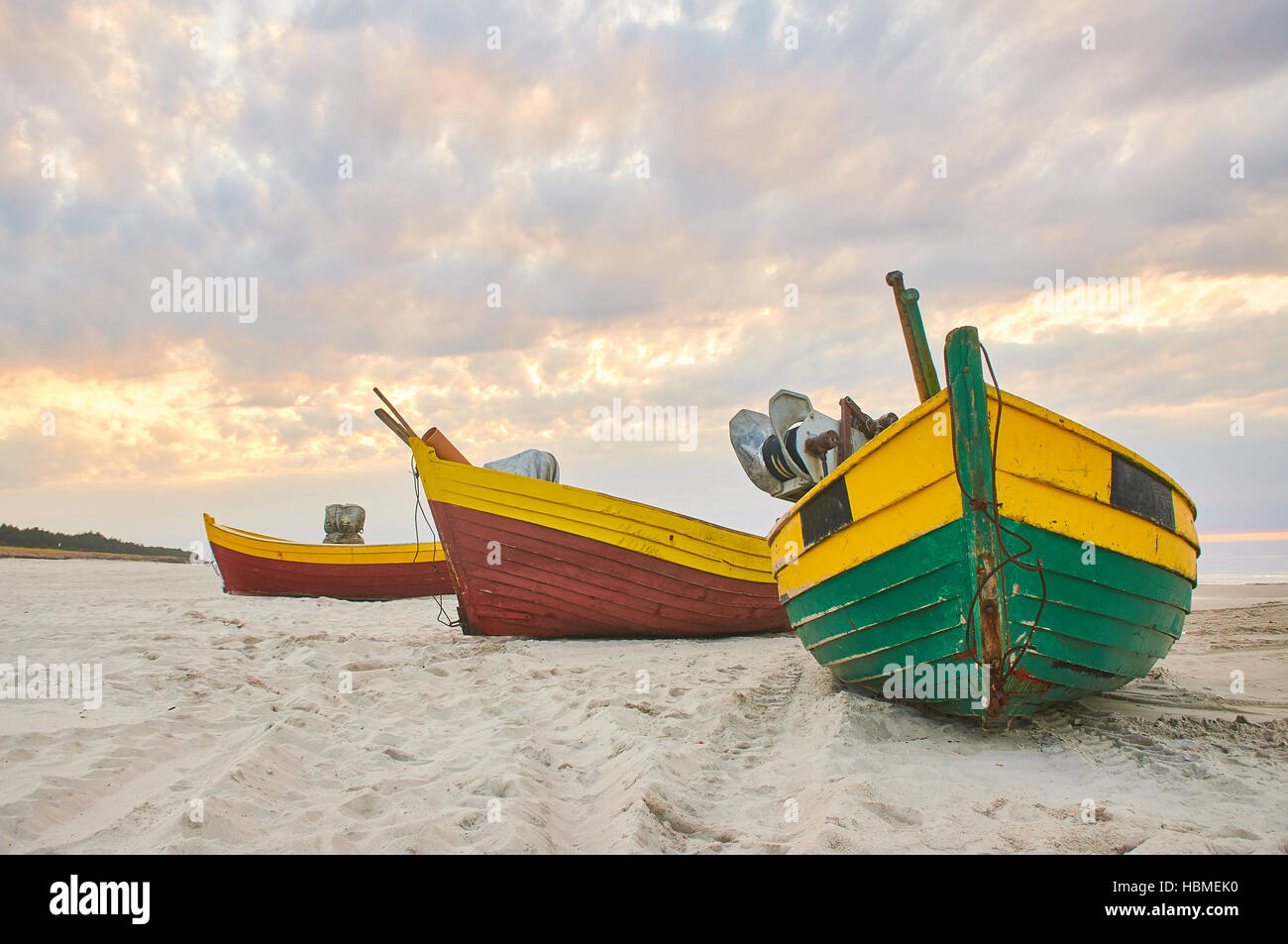 Fishing boat at baltic sea sandy beach with dramatic sky during summertime in Poland Stock Photo