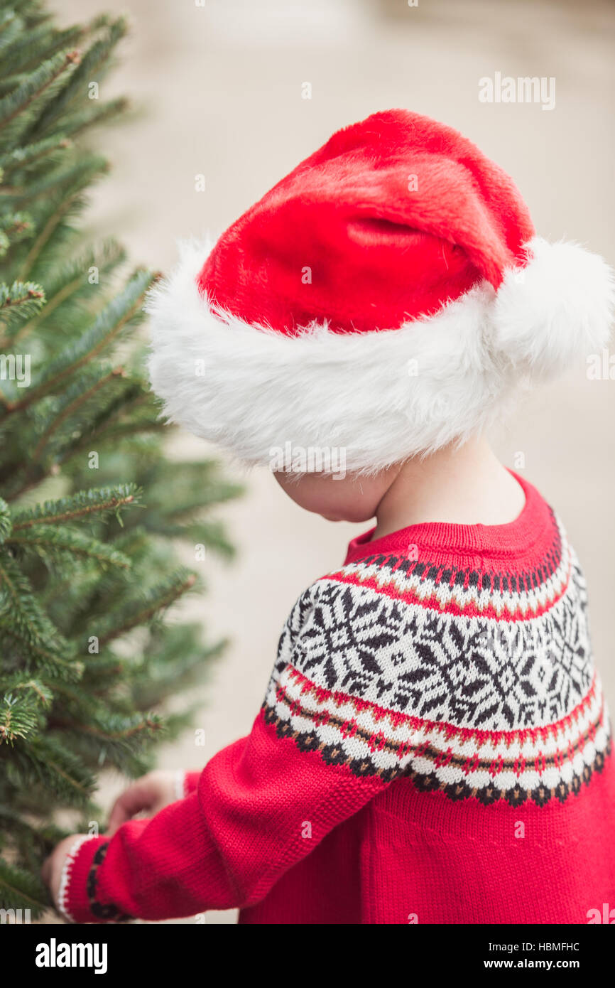 Little girl in red dress on the Christmas tree farm Stock Photo - Alamy