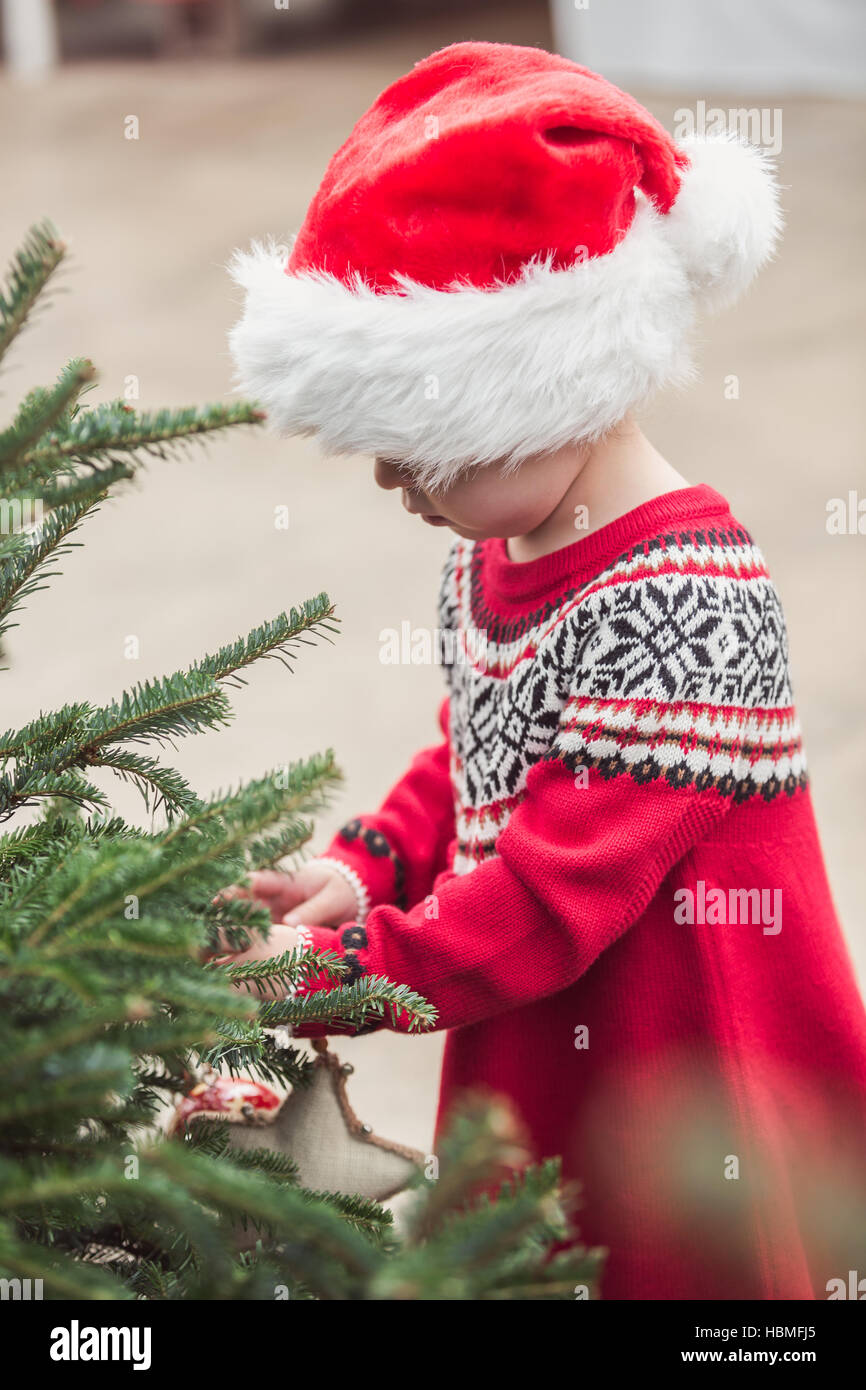 Little girl in red dress on the Christmas tree farm Stock Photo - Alamy
