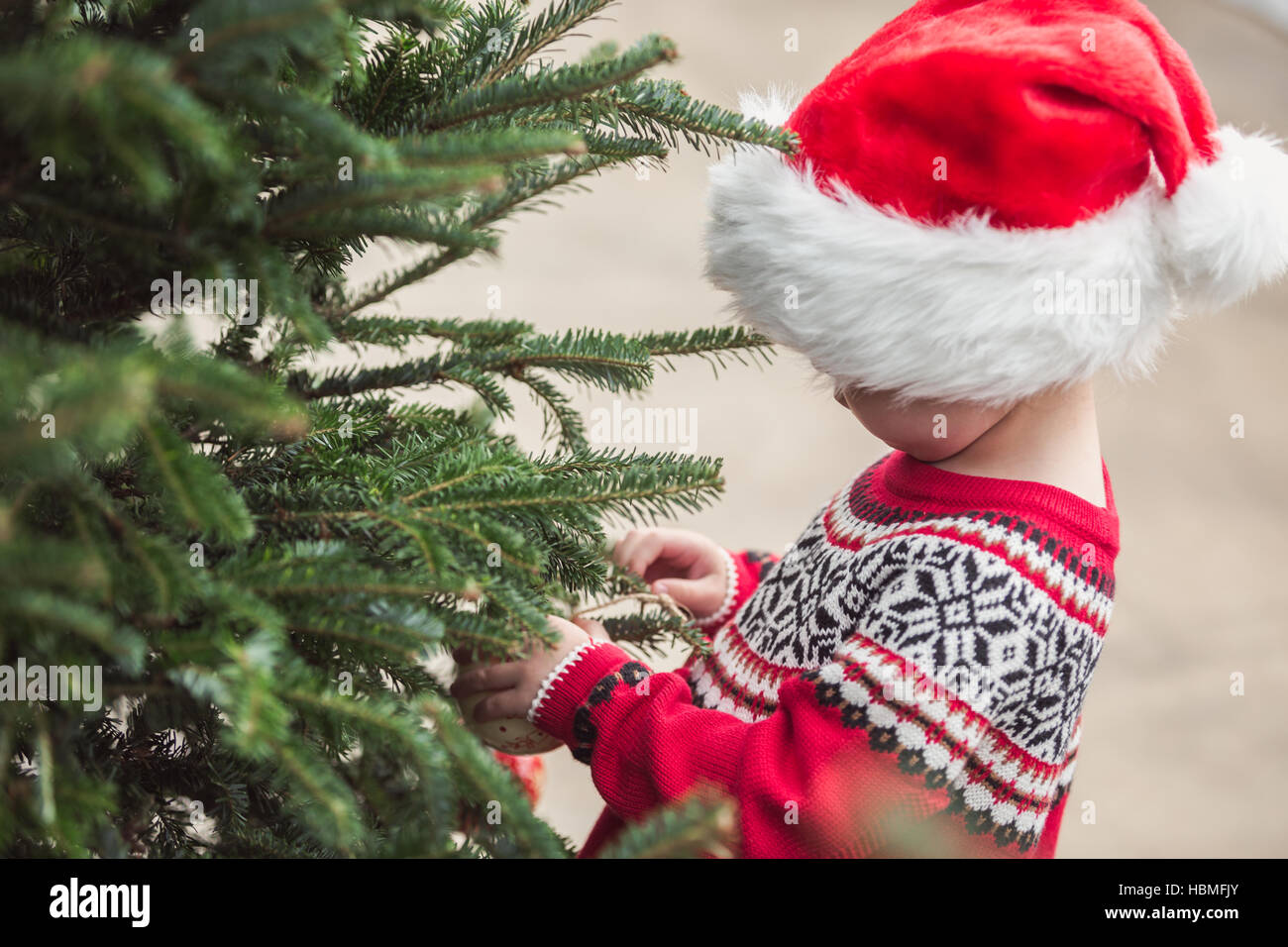 Little girl in red dress on the Christmas tree farm Stock Photo - Alamy