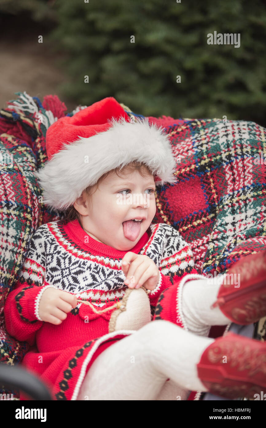 Little girl in red dress on the Christmas tree farm Stock Photo - Alamy