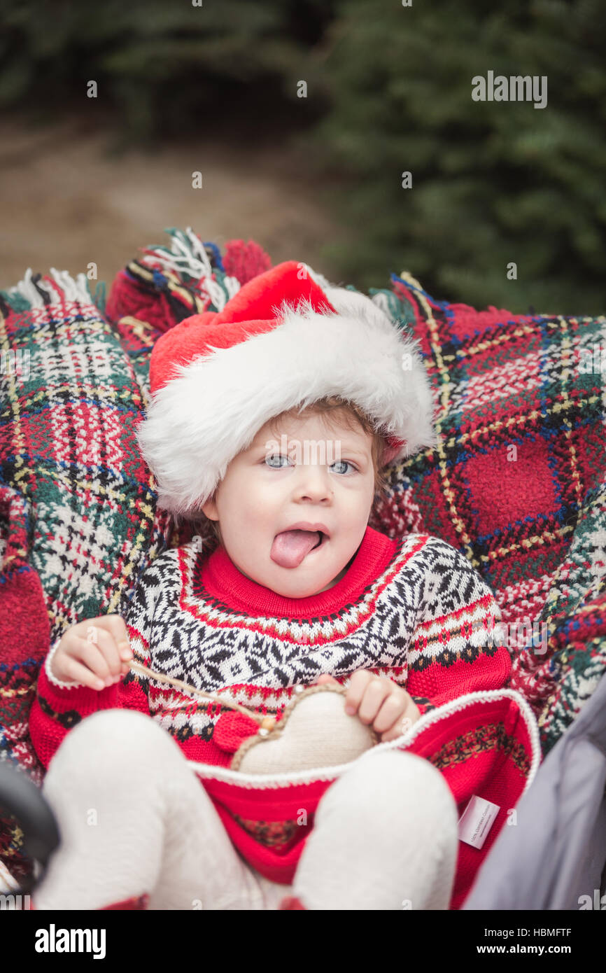 Little girl in red dress on the Christmas tree farm Stock Photo - Alamy