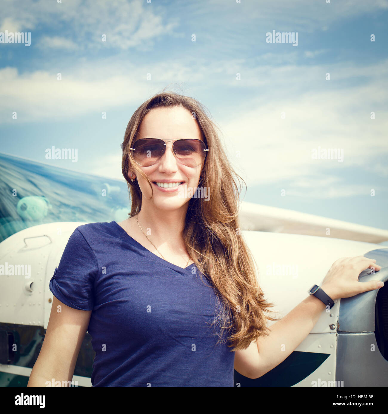 Attractive female airline pilot standing hi-res stock photography and ...