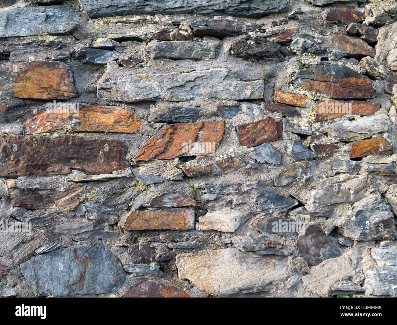 Colorful slate stone and concrete aged wall background Stock Photo