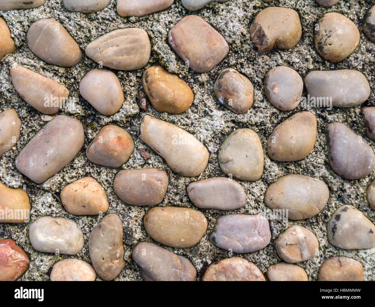 Pebble and concrete old roadway pavement background Stock Photo