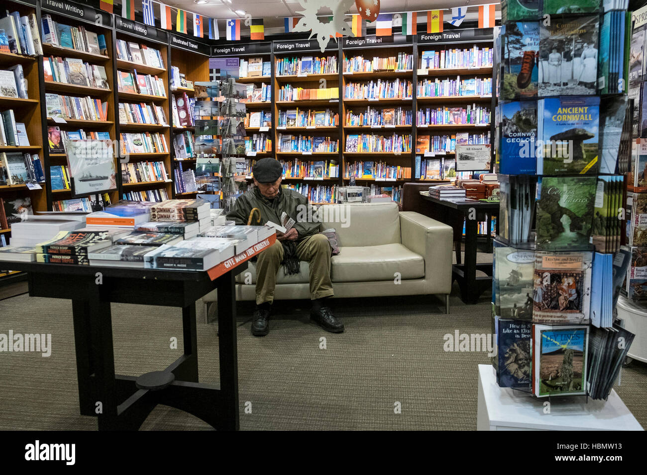 A customer reading a book in a Waterstones Bookshop. Stock Photo