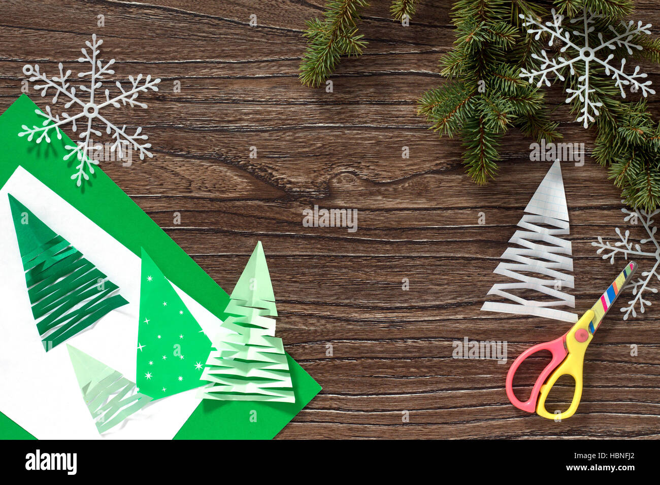 Christmas frame. The child makes paper fir tree. Children's art project