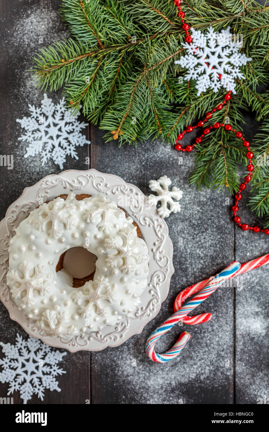 Christmas cake with icing and snowflakes. Stock Photo