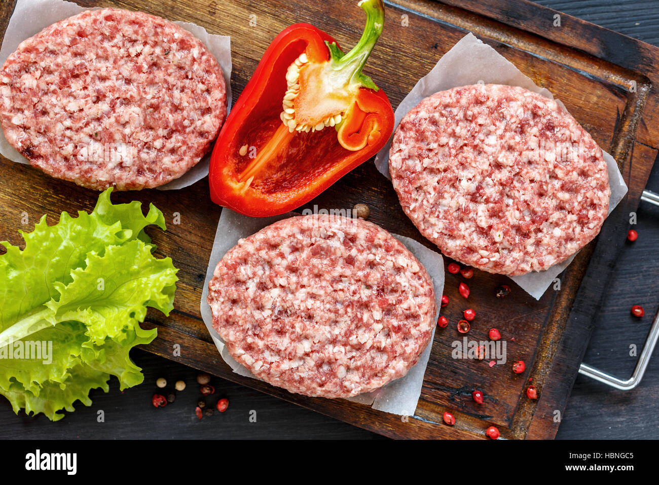 Raw beef cutlets and red pepper. Stock Photo