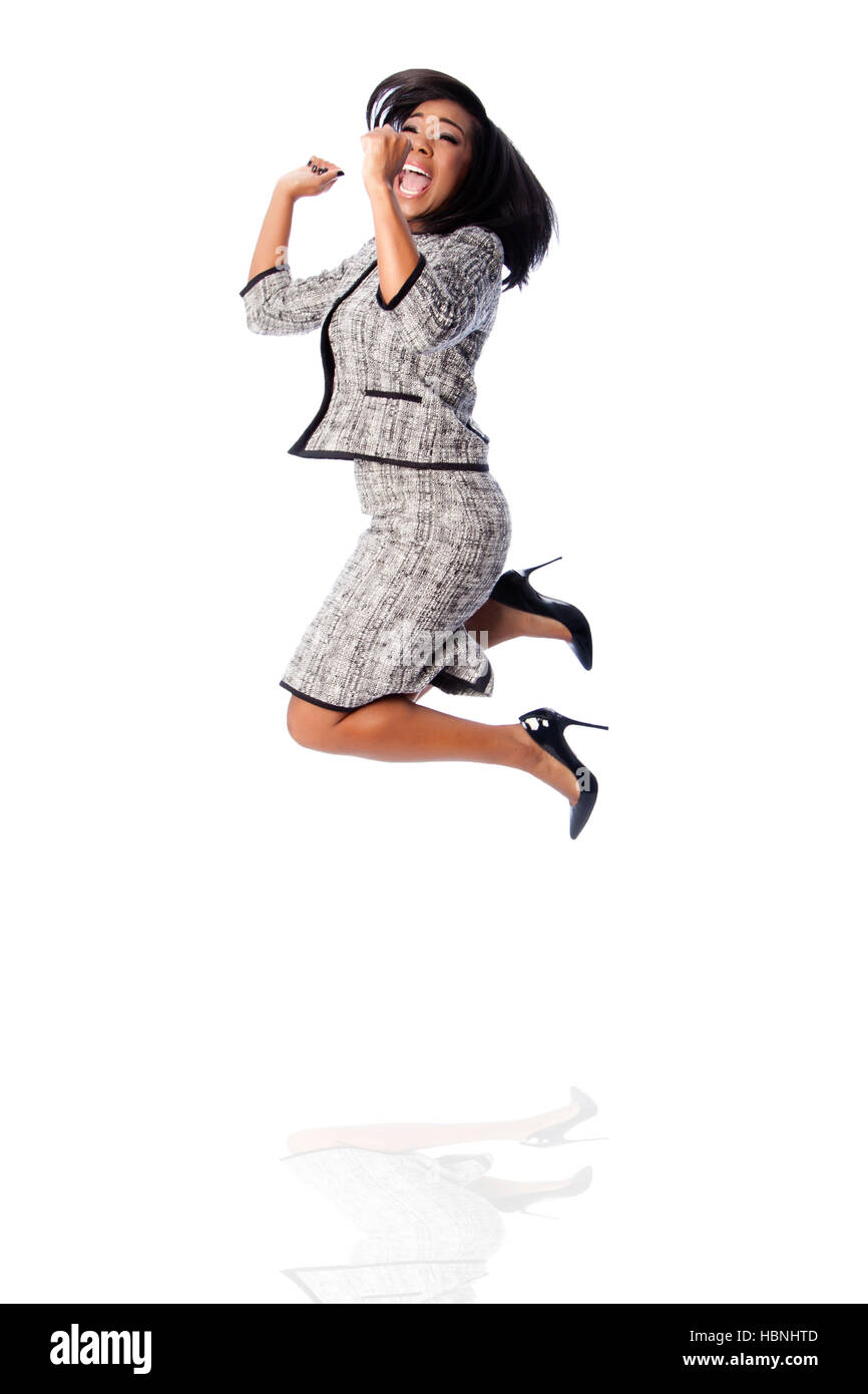 Winning business woman jumping cheering Stock Photo