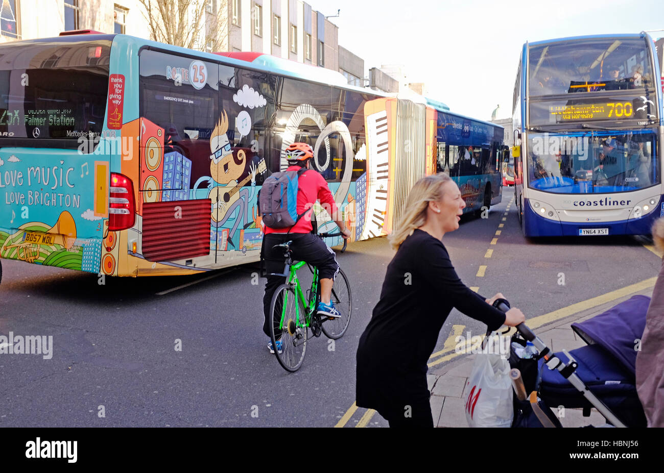 Cyclists and pedestrians amongst buses and traffic congestion in Western Road Brighton UK Stock Photo