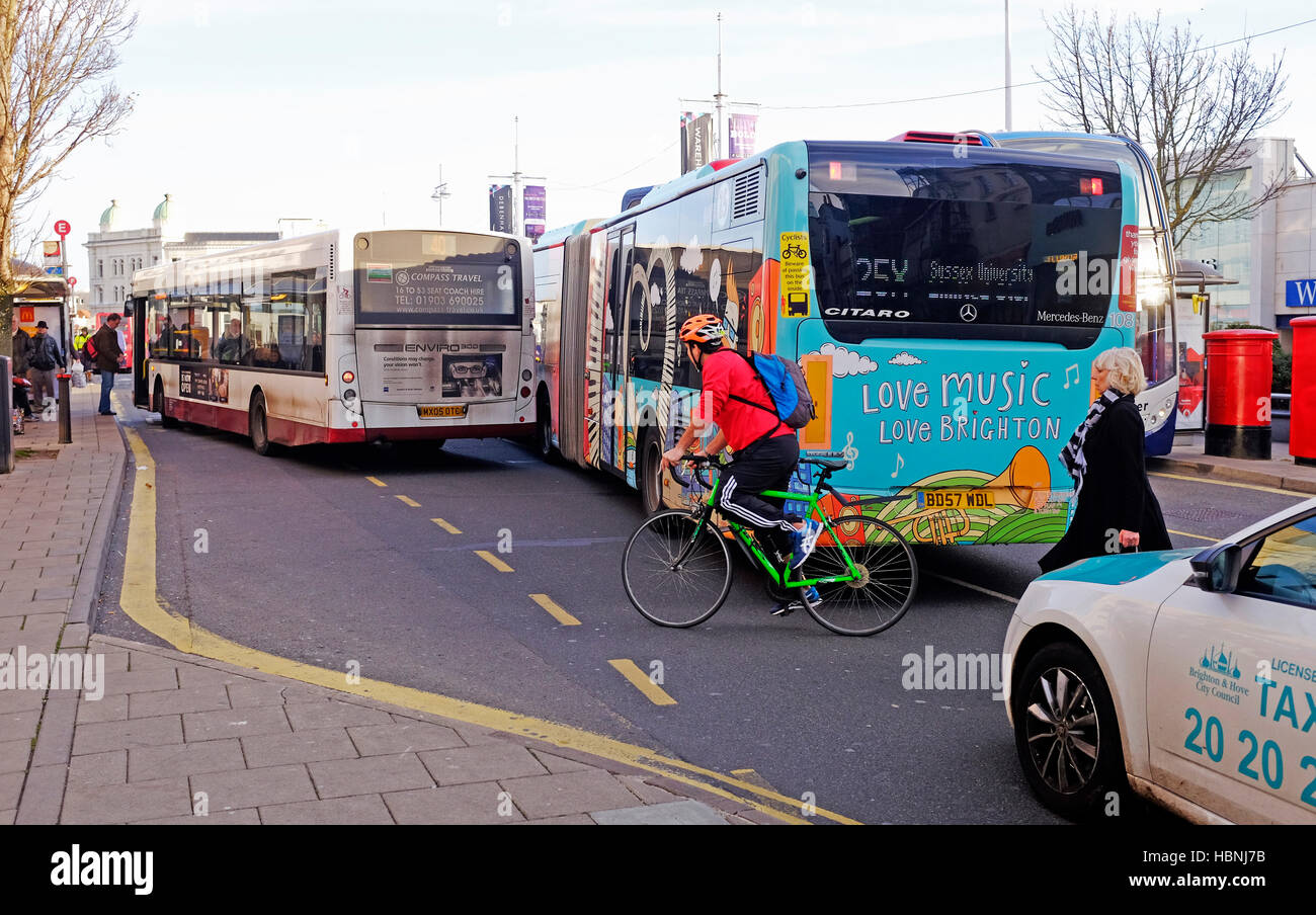 Cyclists and pedestrians amongst buses and traffic congestion in Western Road Brighton UK Stock Photo