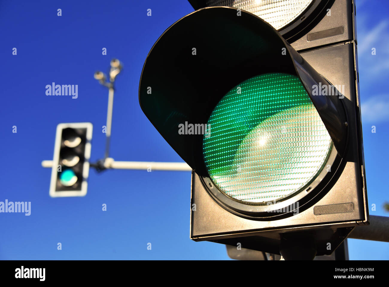 Traffic lights over blue sky. Green light Stock Photo