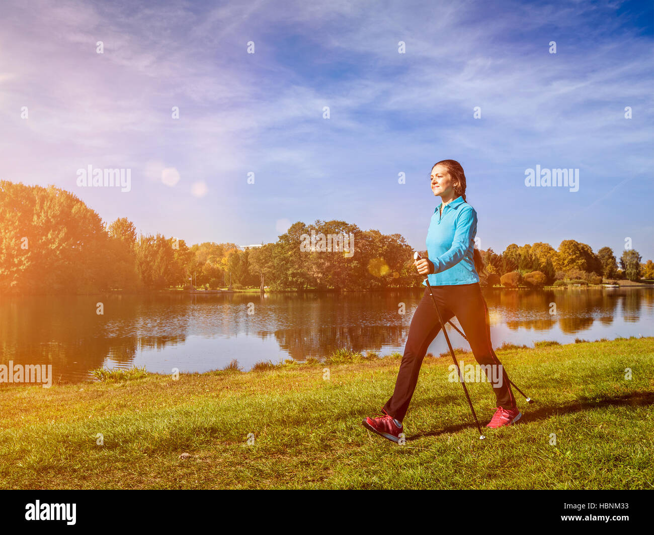 Nordic walking woman outdoors Stock Photo