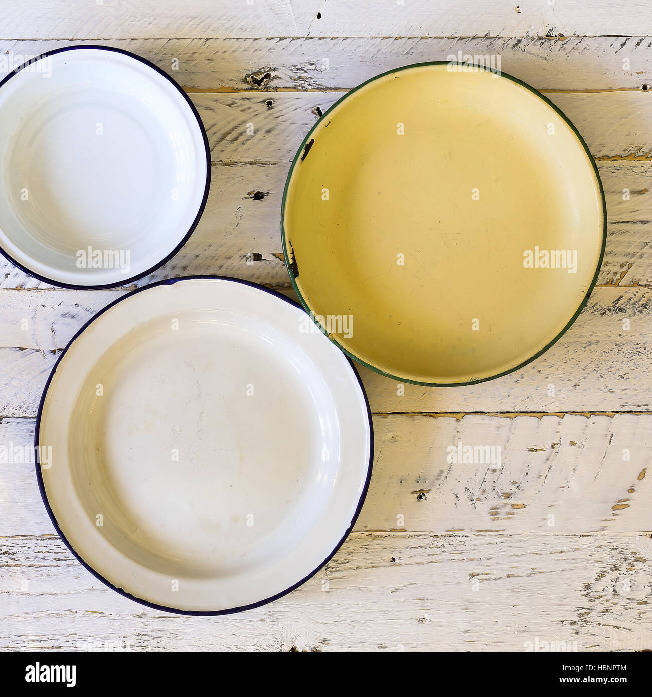 Set of plates with vintage shape border pattern assorted ceramic china on white painted rough wood background Stock Photo