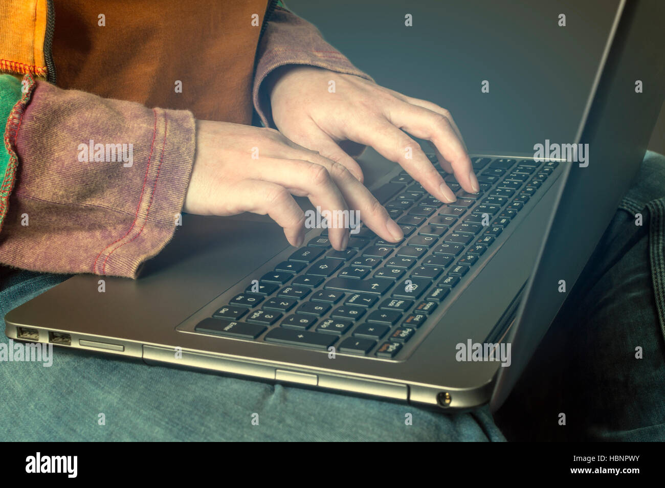 Hand typing on a laptop. Business, technology, internet and networking concept. Stock Photo