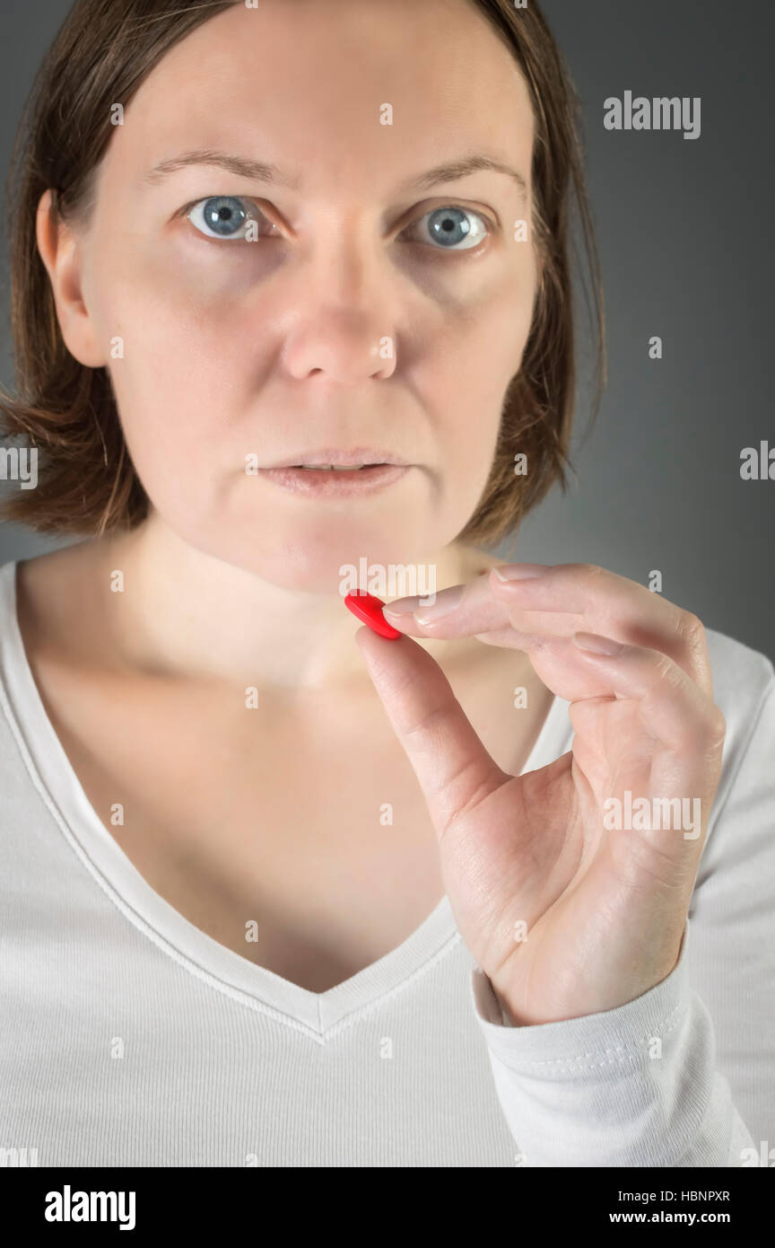 Close up of woman taking in pill. Medicine, health care concept Stock Photo