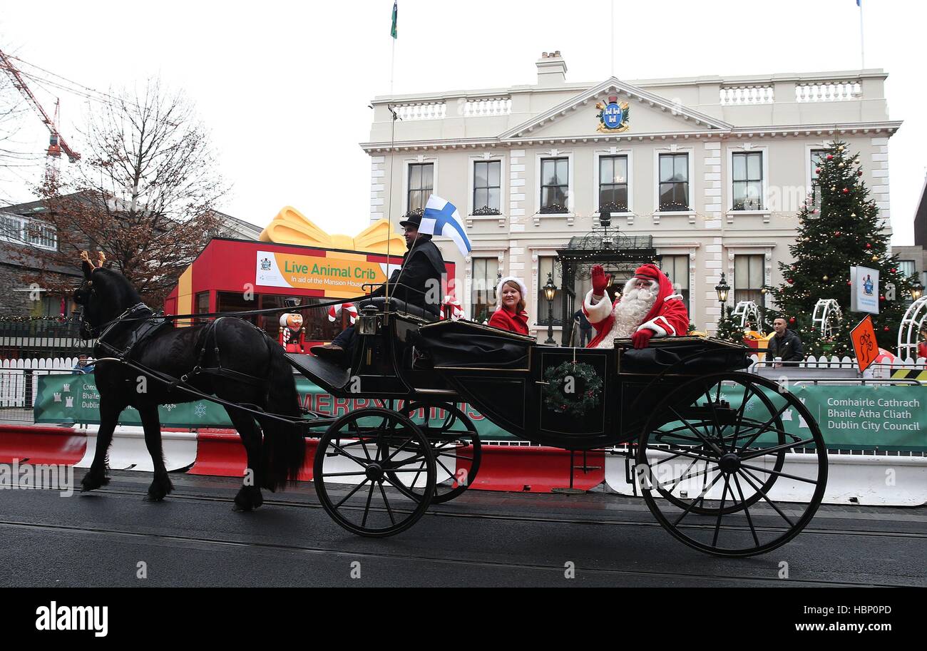 Santa and Mrs. Claus depart in a horse drawn carriage following the ...