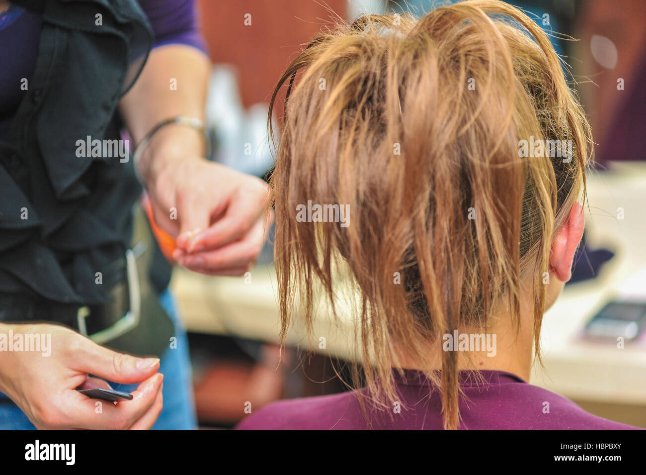 Hairdresser applying hair gel Stock Photo