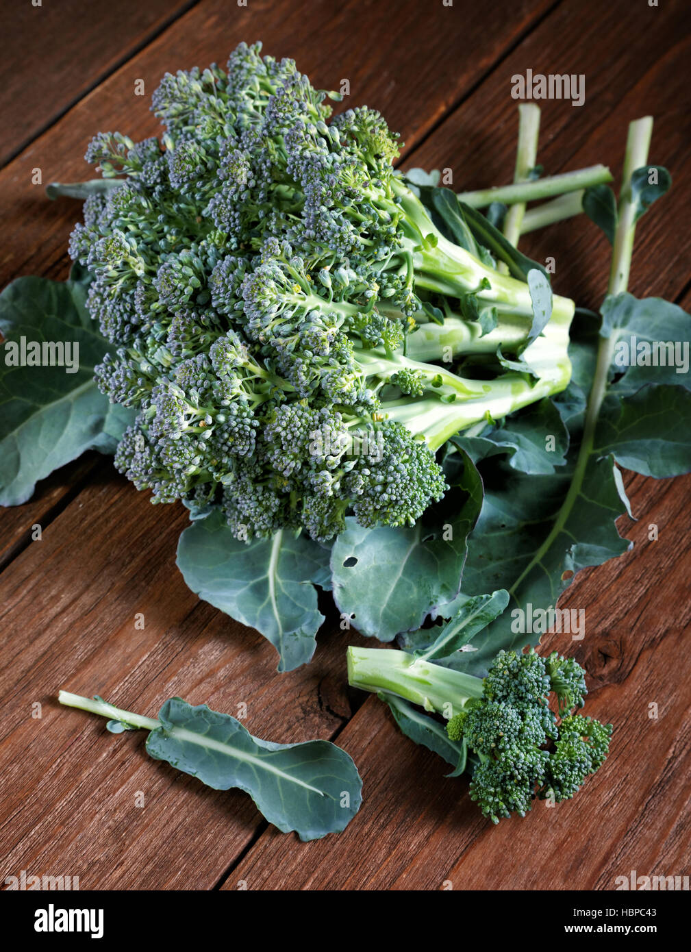 head of broccoli with leaves in a table Stock Photo Alamy