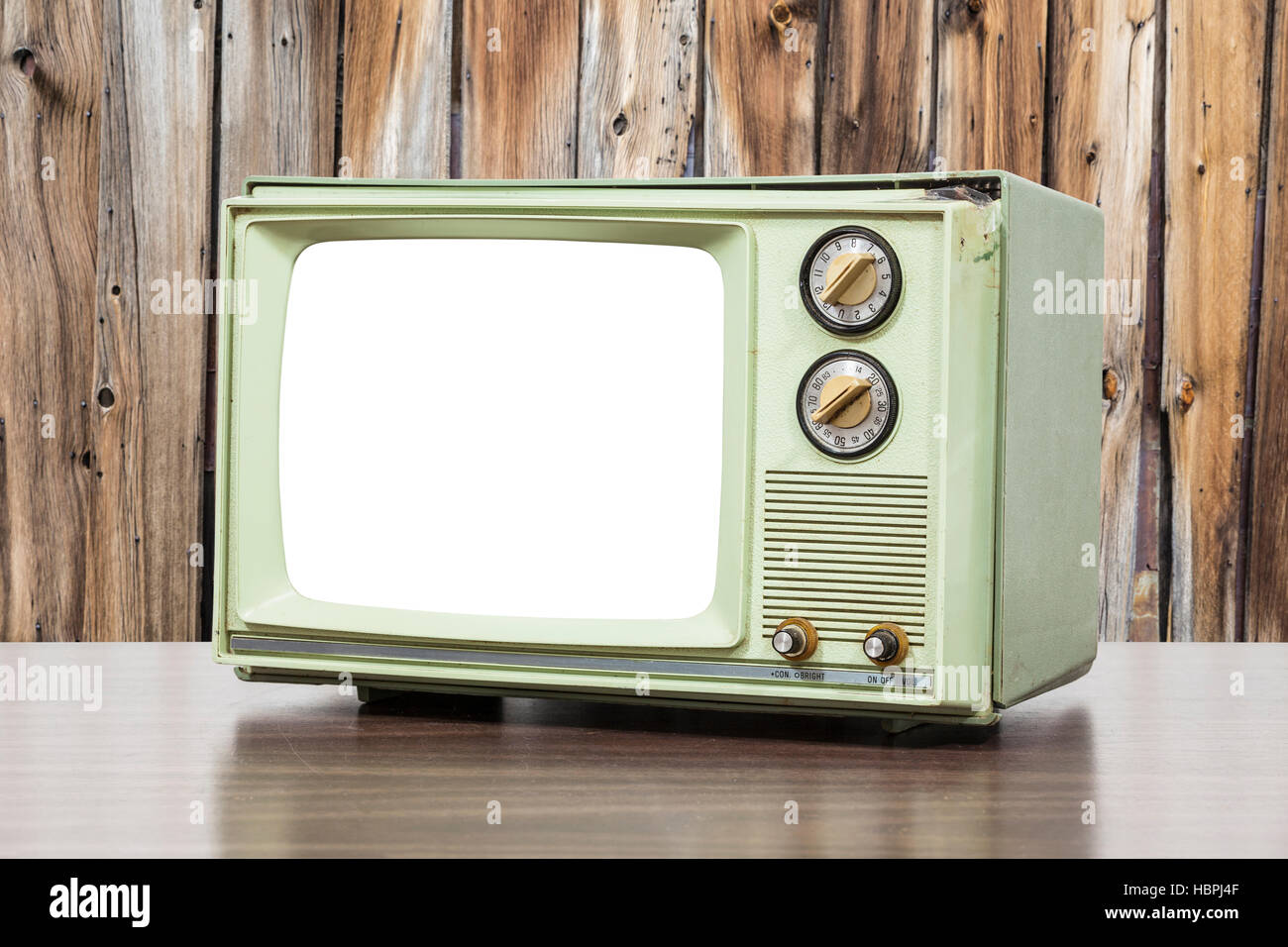 Green vintage television with old wood wall. Stock Photo