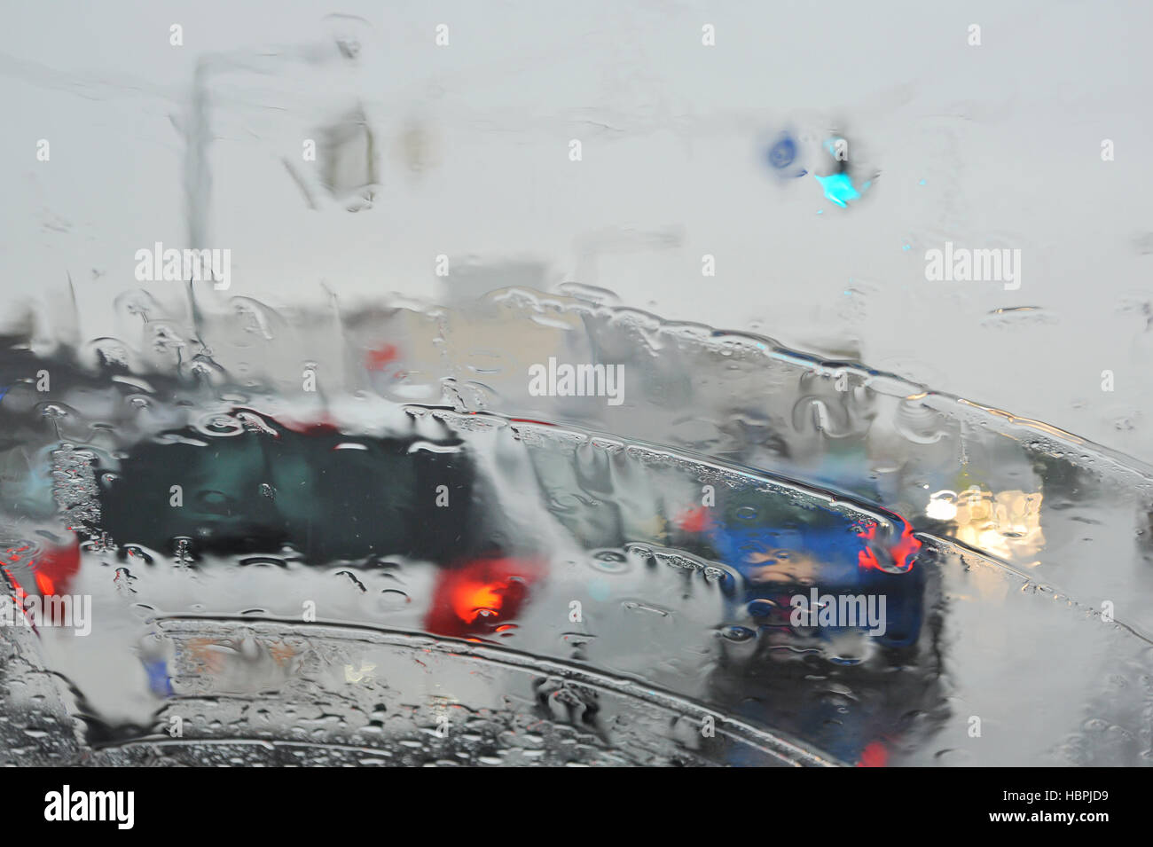 Rainy weather on the road with vehicles Stock Photo