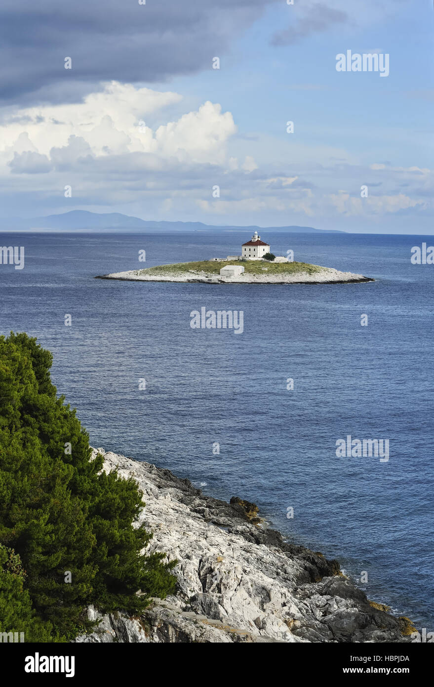 Island with lighthouse in the sea Stock Photo