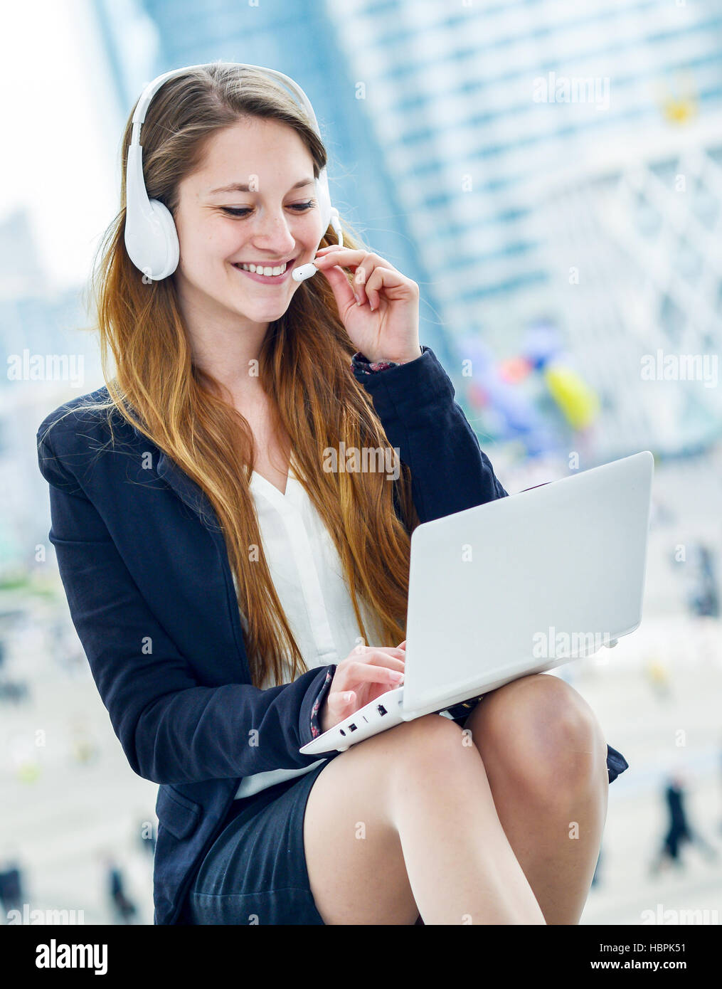 Blonde support operator in headset outdoor Stock Photo