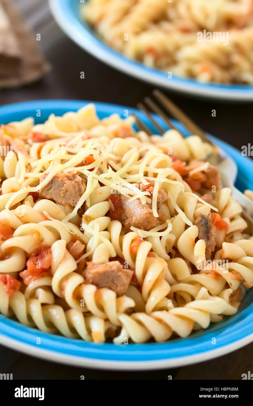 Rotini pasta with tuna and tomato sauce and grated cheese on top, photographed with natural