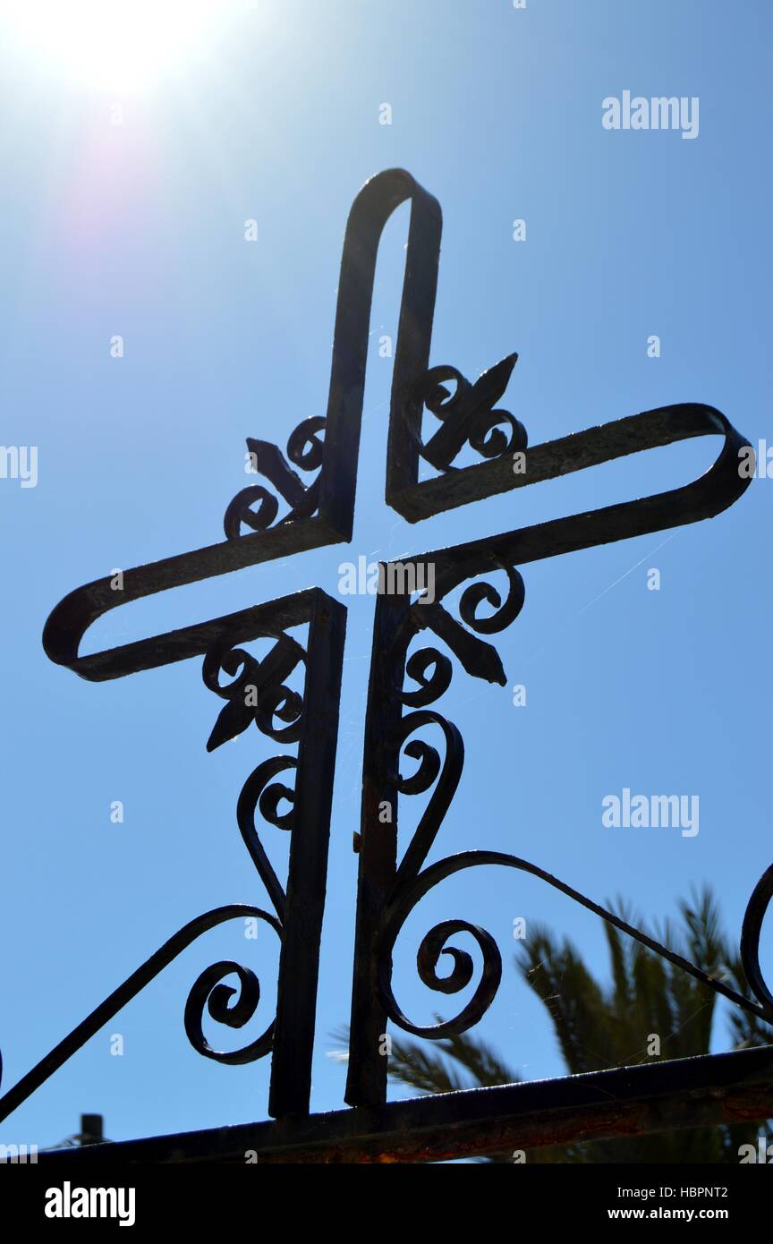 A cross on a black metal wall Stock Photo Alamy