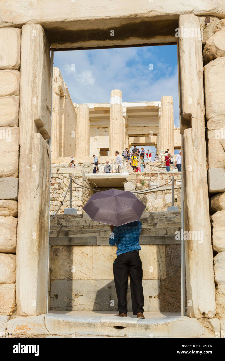 Athens, Greece - August 25, 2016: Man Entering the Acropolis Holding an Umbrella Stock Photo