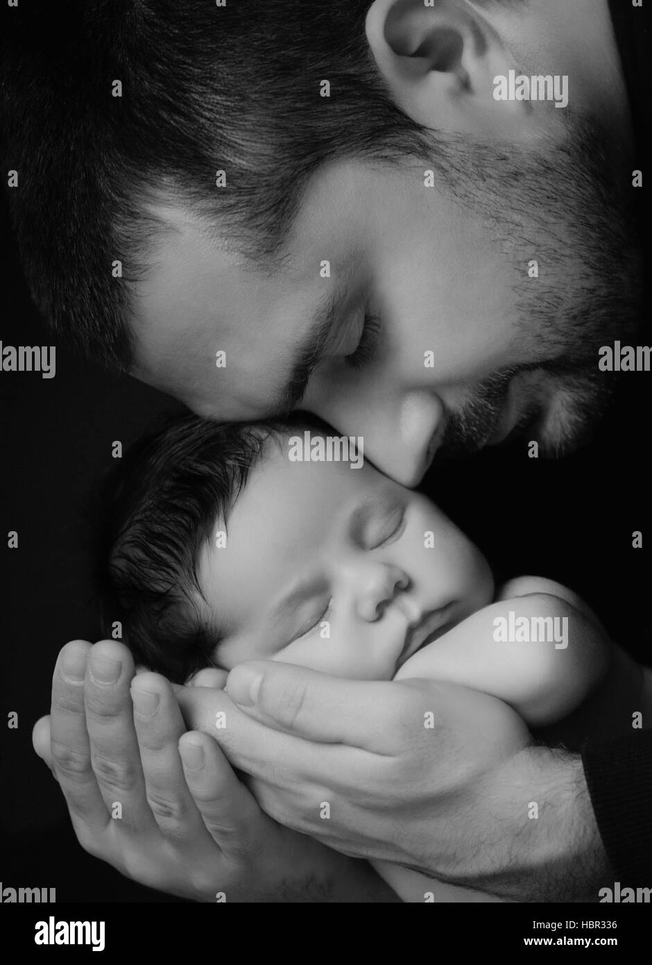 Daddy Hugs His Newborn Baby Father S Love Close Up Portrait On A Black Background Stock Photo Alamy