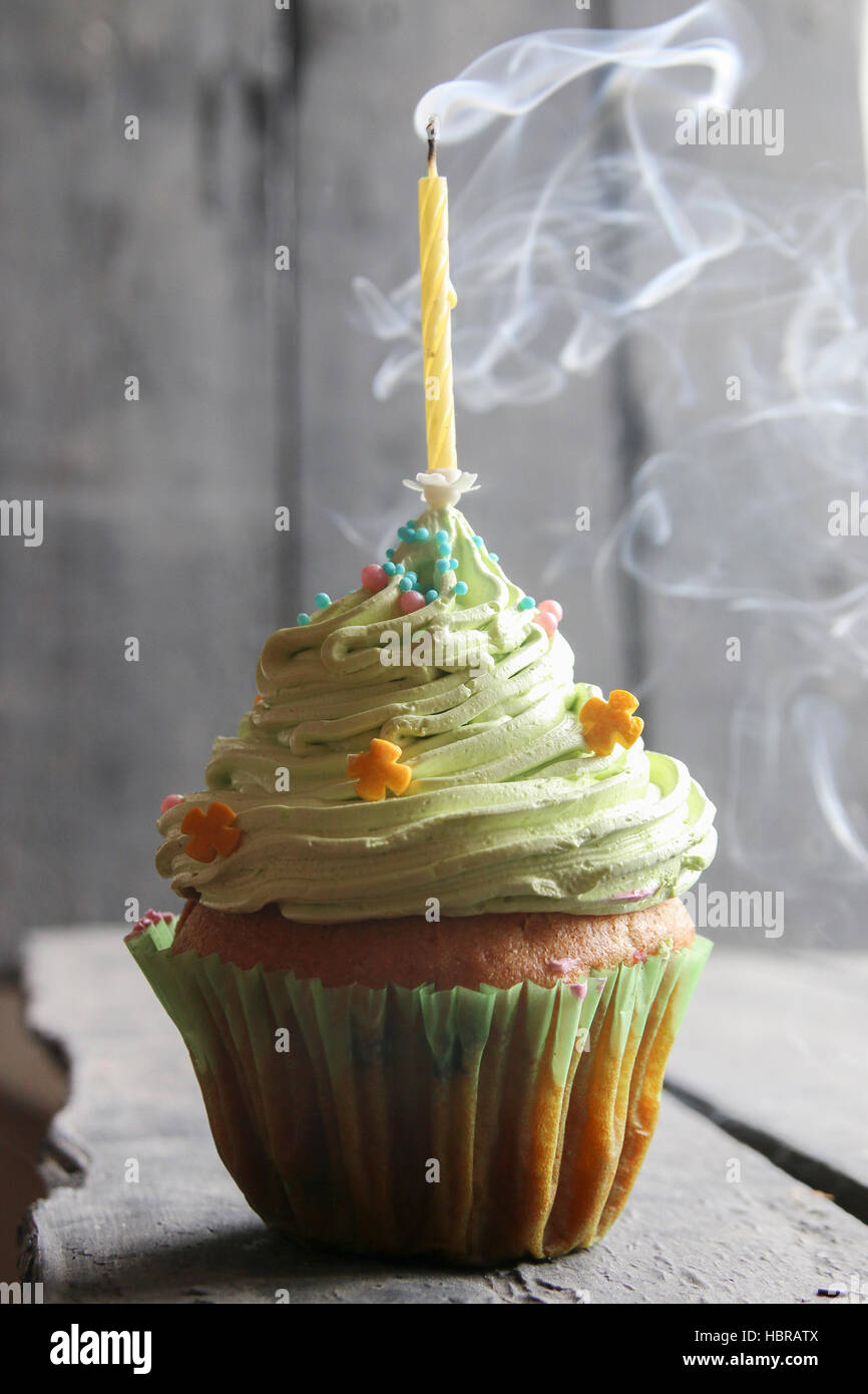 Birthday cake with one candle on the old dark table Stock Photo Alamy