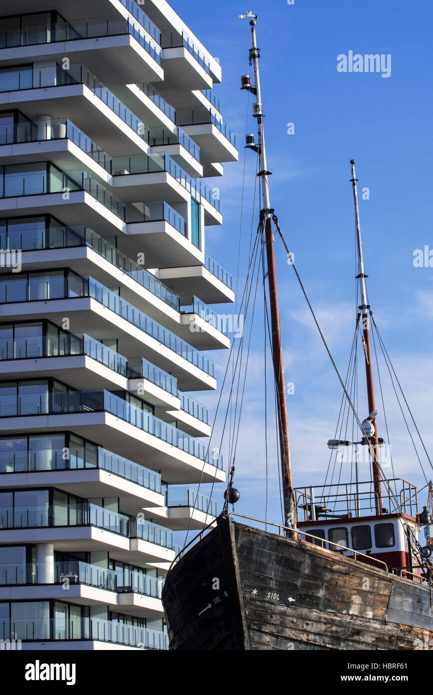 Old fishing boat and new flat being build for real estate project