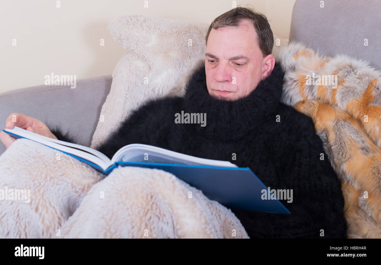 man is sick and reads a book Stock Photo