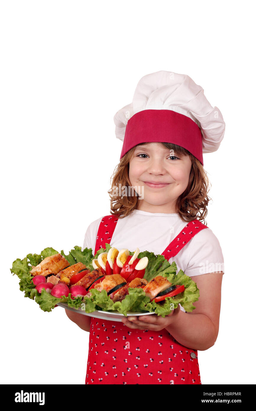 beautiful cheerful little girl cook with gourmet food Stock Photo