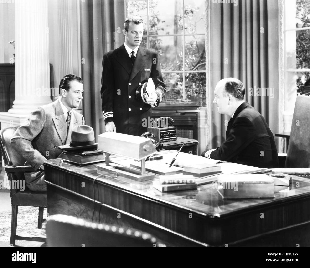 THE FIGHTING SEABEES, from left: John Wayne, Dennis O'Keefe, Addison ...