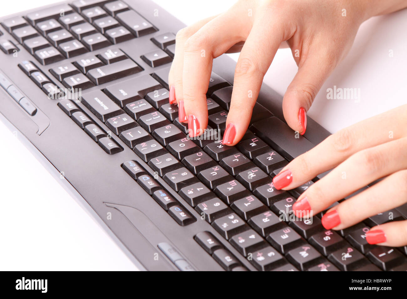 Woman fingers typing on keyboard Stock Photo