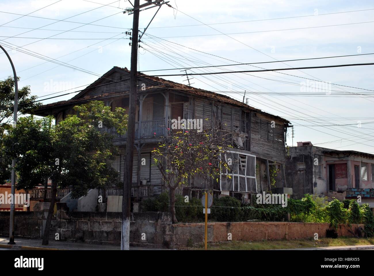 Old wooden house that collapses in the city Stock Photo