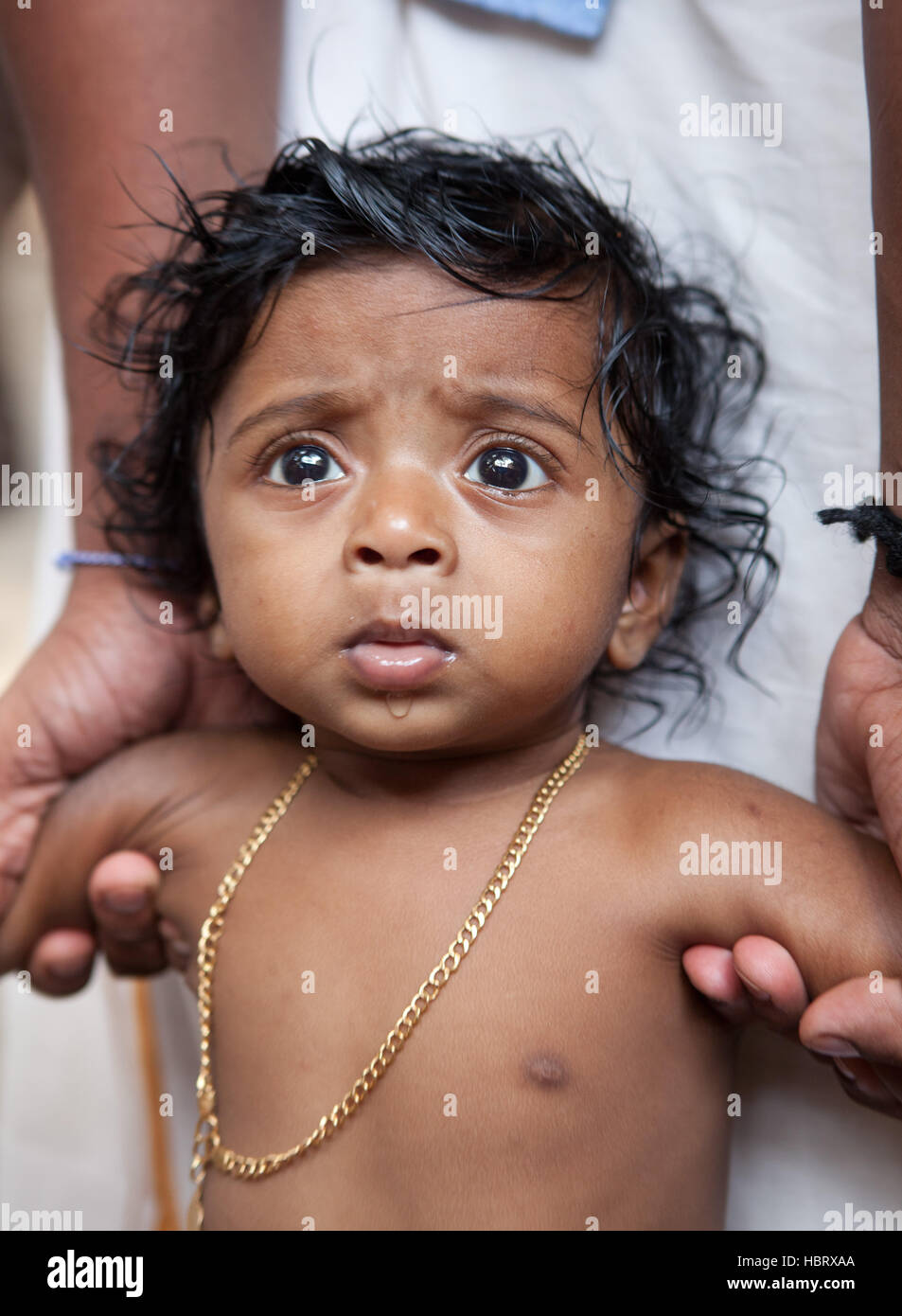 Portrait of anxious looking baby in Kerala,India Stock Photo