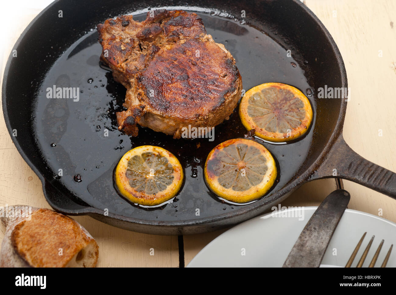 pork chop seared on iron skillet Stock Photo Alamy