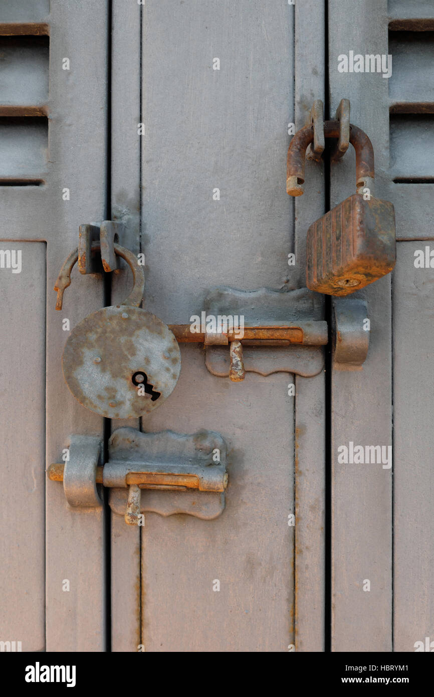 rusty old padlocks and locking bolts on metal doors Stock Photo - Alamy