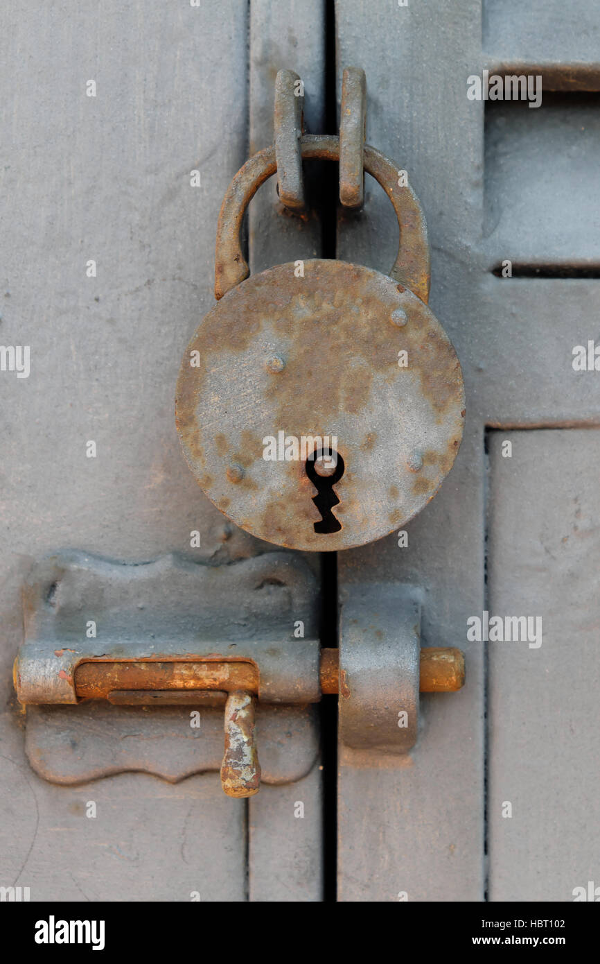 old vintage padlock, closed metal door Stock Photo