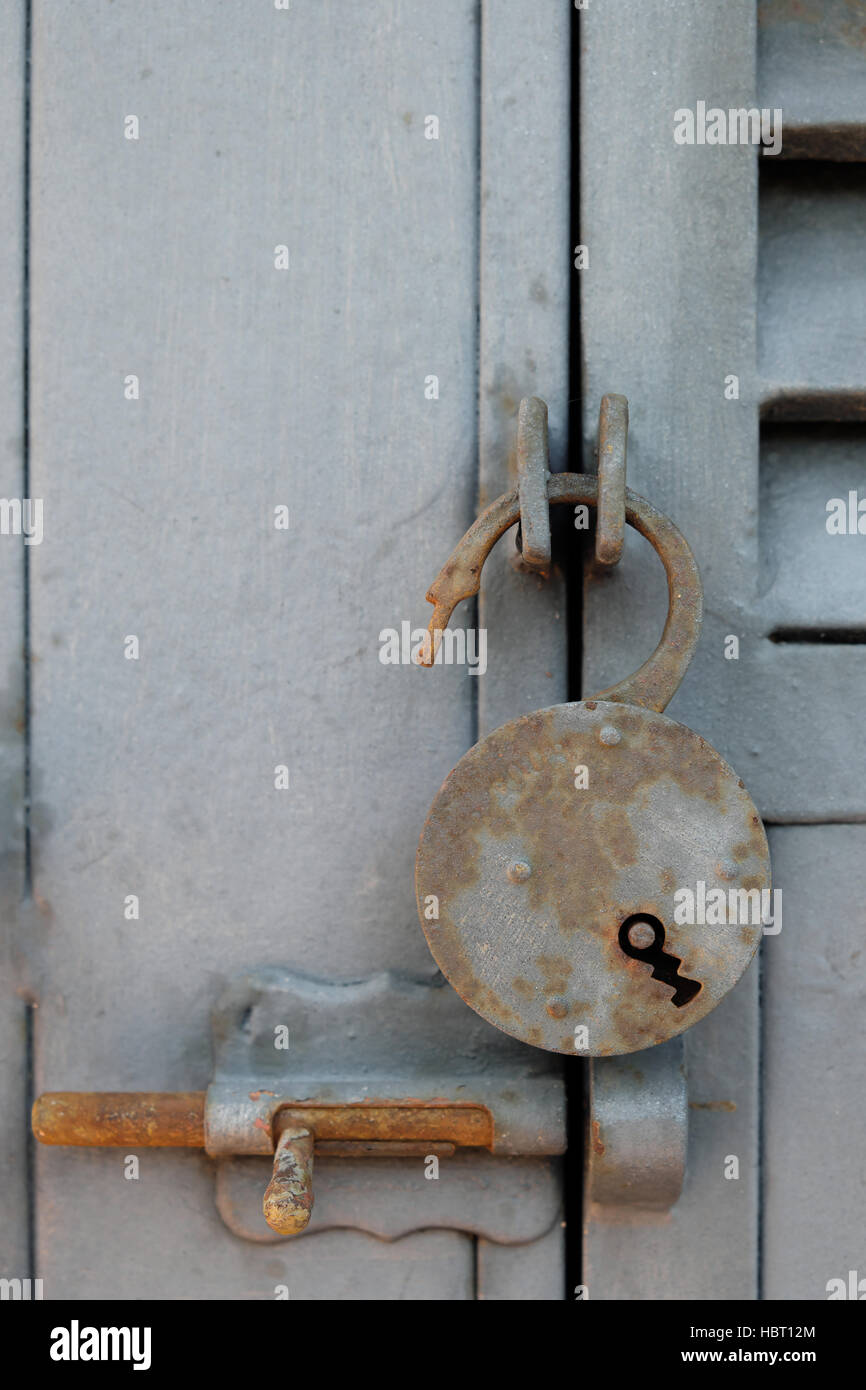 open rusty padlock on metal door - vintage lock Stock Photo