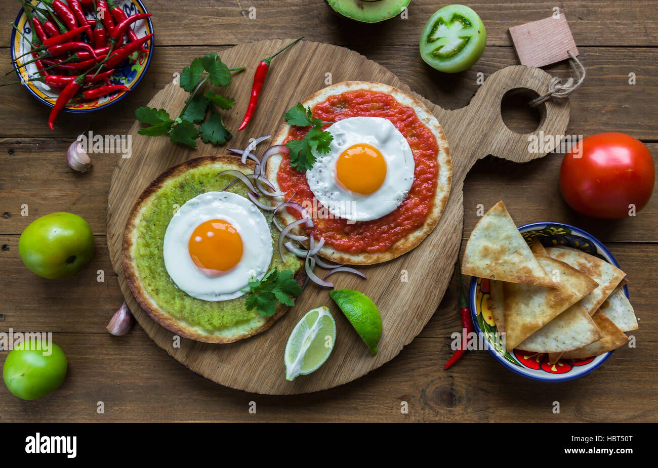 huevos divorciados, fried eggs on corn tortillas with salsa verde and  roja, mexican breakfast Stock Photo